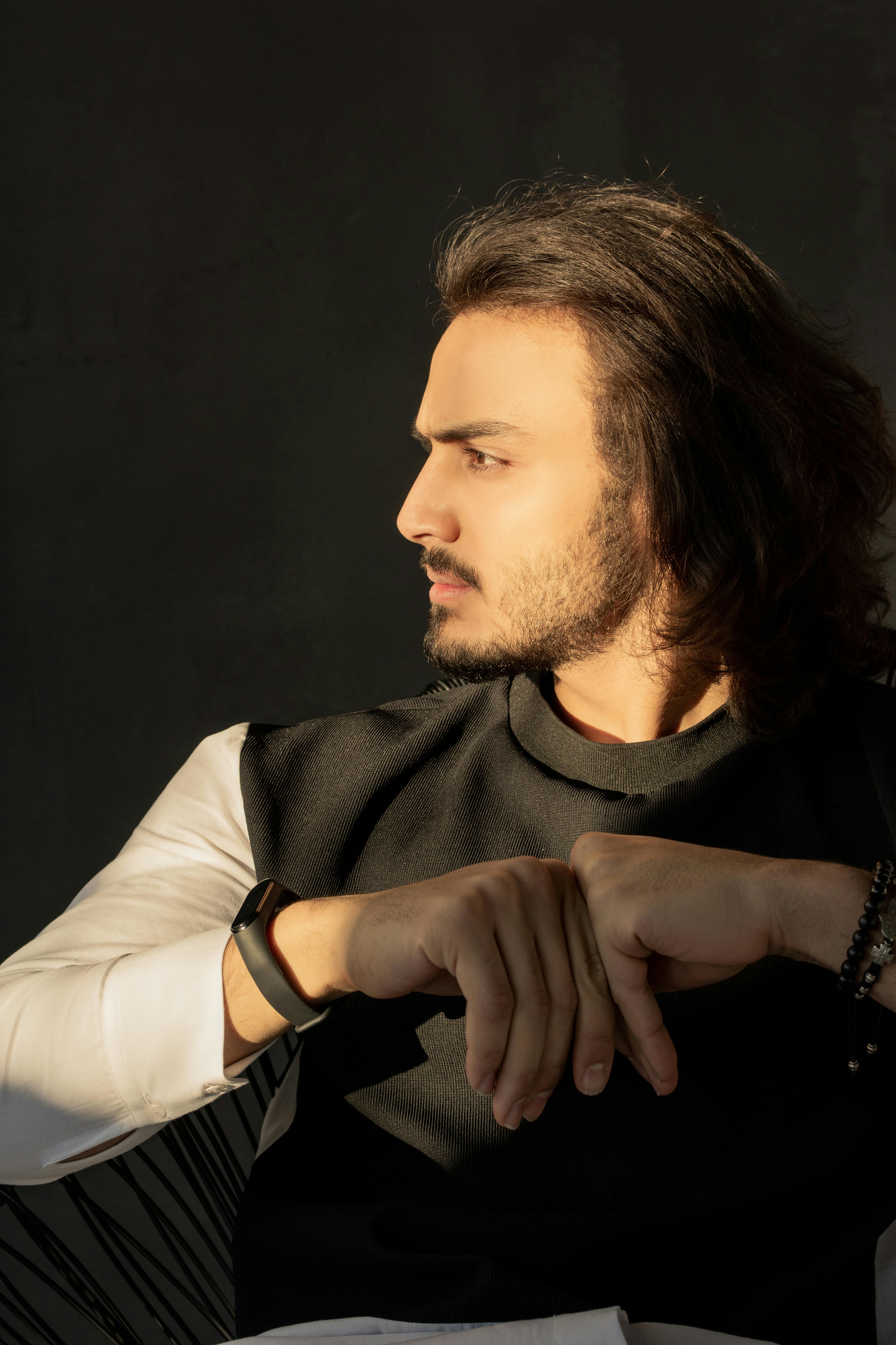 一个男人坐在室内，侧脸被自然阳光照亮