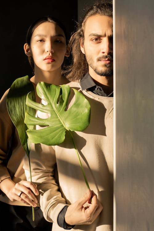 Free Couple Holding Green Leaves Stock Photo