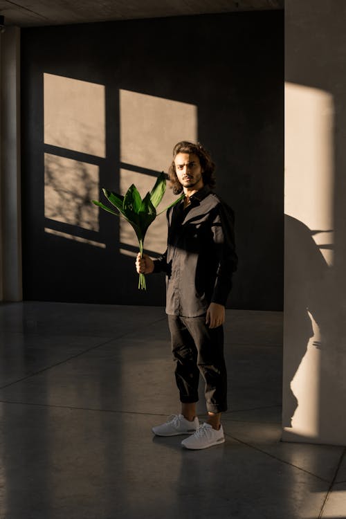 Photo Of Man Holding Leaves