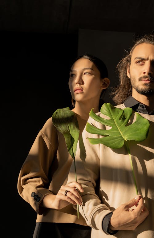 Couple Holding Green Leaves