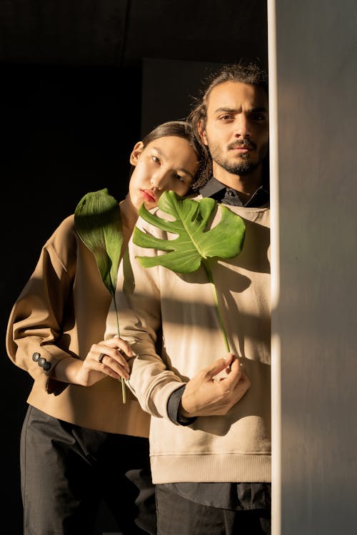 Couple Holding Green Leaves