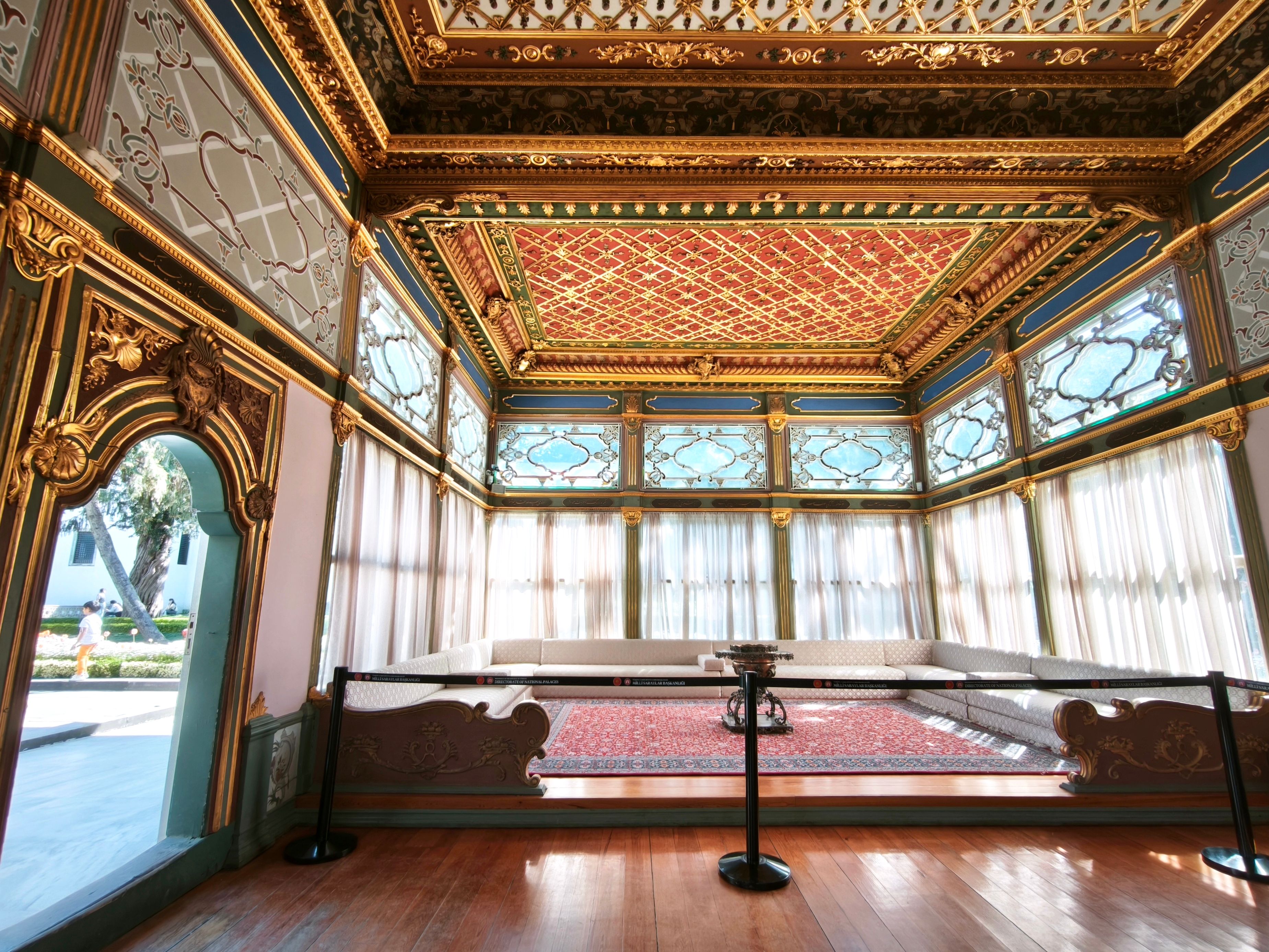 Elaborate golden architectural design in an opulent historical palace room, richly decorated and luxurious.