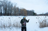 Man playing guitar outdoors in a snowy landscape in Montreal, Canada. Capturing winter vibes.
