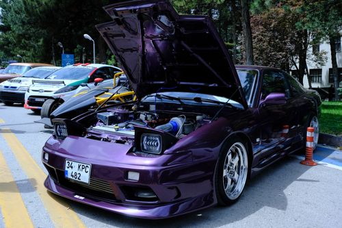 Free A vibrant purple sports car with an open hood displayed in a car show in Ankara, Türkiye. Stock Photo