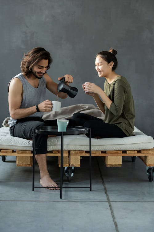 Free Man and Woman Sitting on Bed Stock Photo