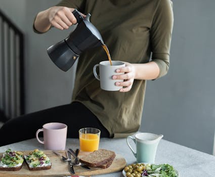 A relaxed breakfast scene featuring coffee, avocado toast, and fresh orange juice.