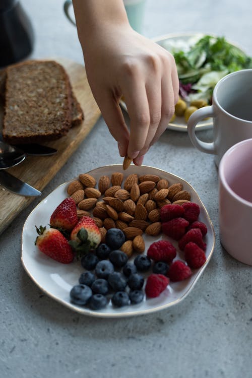 Free Photo Of Person Holding Almond Stock Photo