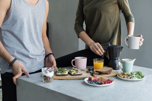 Free Cozy morning breakfast with avocado toast, coffee, and fresh juice. Stock Photo