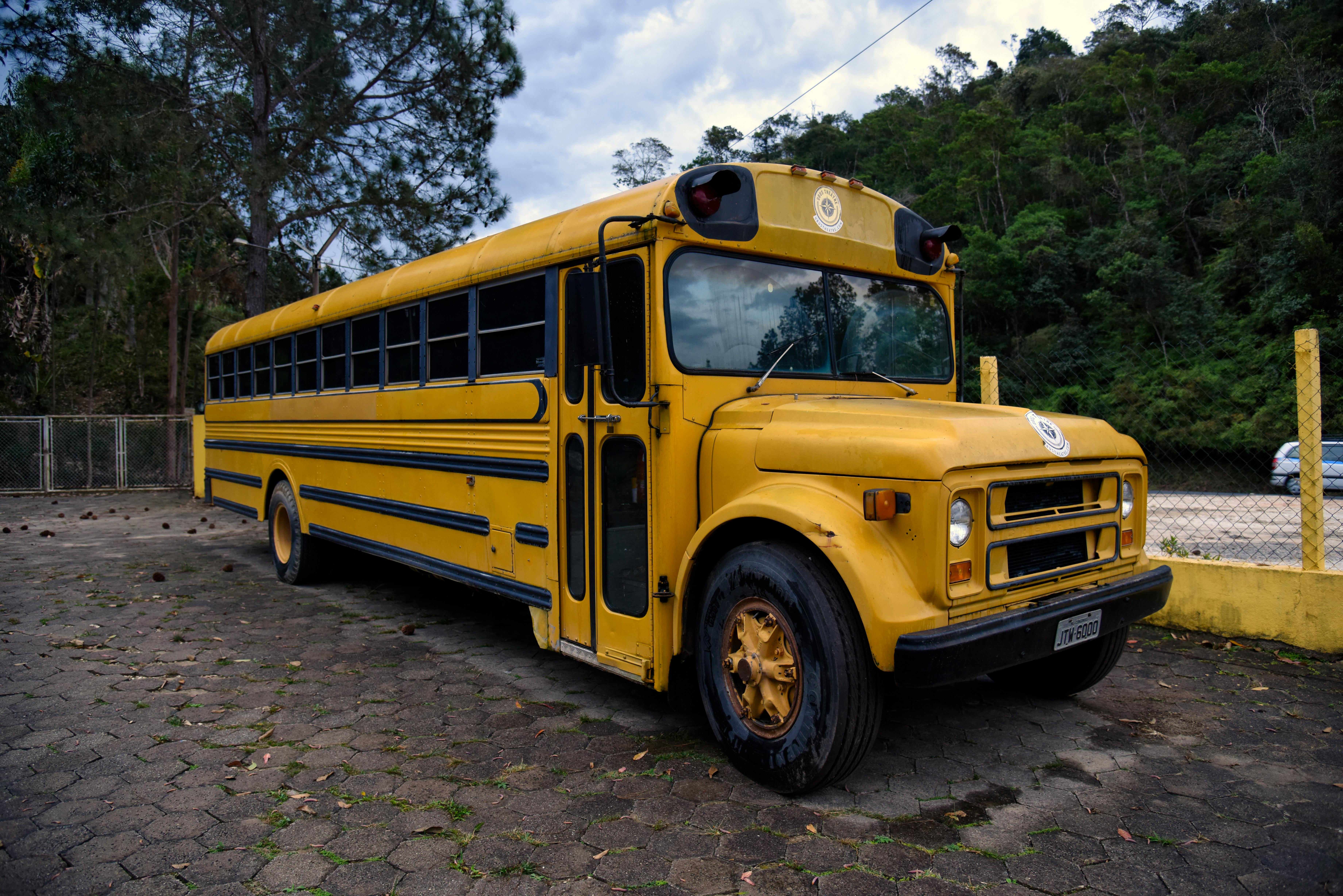Vintage yellow school bus parked outdoors in Ubatuba, São Paulo, Brazil. A nostalgic travel scene.