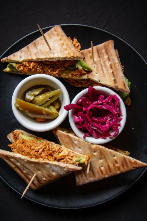 Free Authentic Mexican tlayudas served with pickled jalapeños and red cabbage. A taste of León, Mexico. Stock Photo