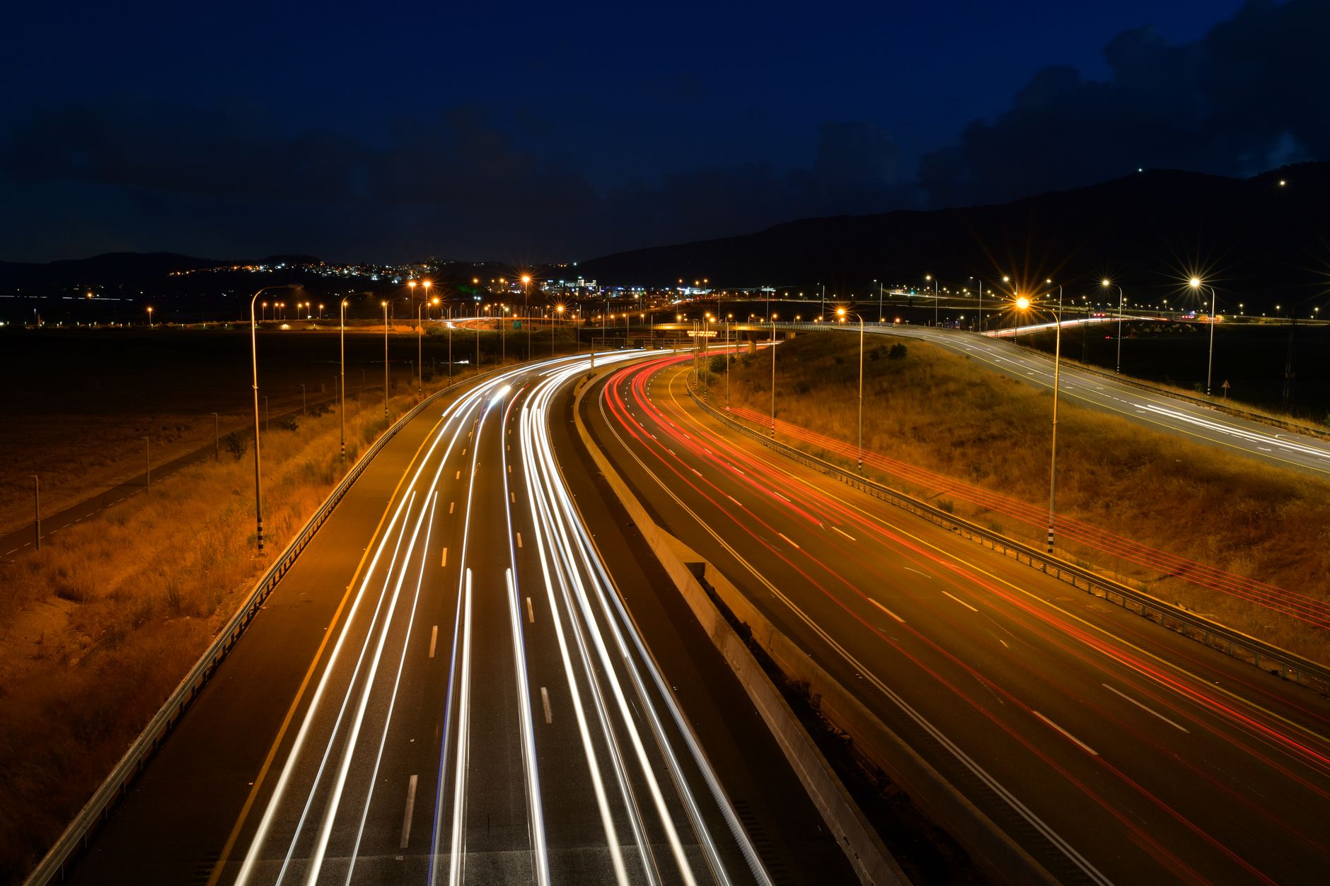 Stunning long exposure of a highway capturing light trails from vehicles at night.