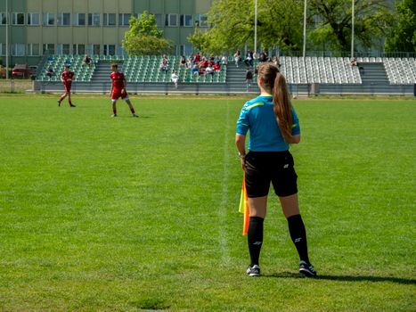 Female football referee oversees a match at a stadium in Wrocław, Poland.