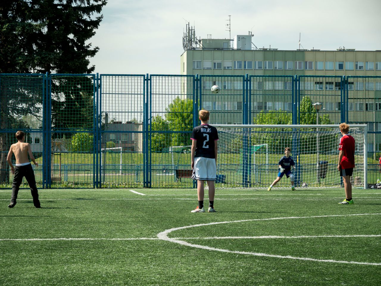 teenagers enjoying a soccer game on an outdoor field in wroc aw poland