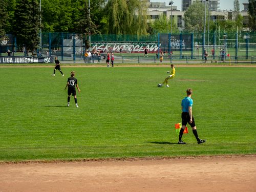 Free Youth soccer game at Wrocław sports field on a sunny day with players and referee in action. Stock Photo