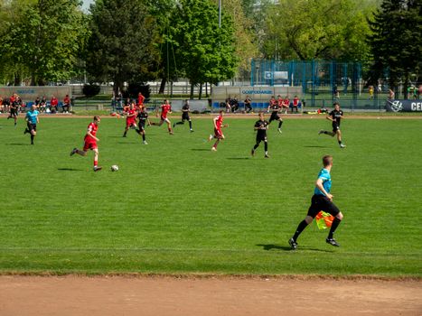 Exciting youth soccer match on a sunny day in Wrocław, Poland, showcasing teamwork and athleticism.