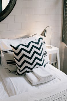 Stylish modern bedroom featuring a chevron pillow and sleek minimalist design.