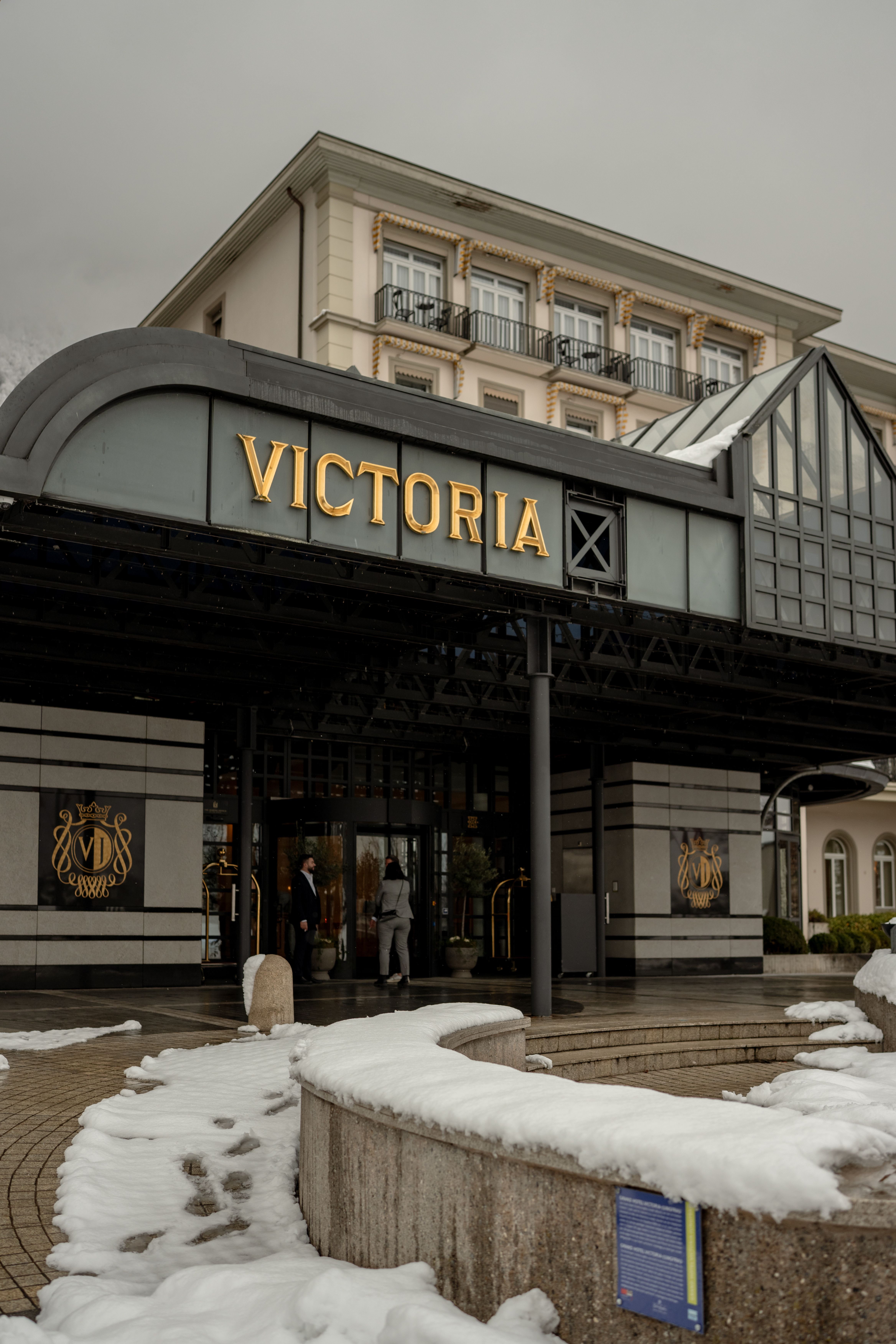 Grand hotel entrance covered in snow in winter, Switzerland