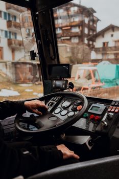 Close-up of a driver operating machinery in Zermatt, Switzerland during winter.
