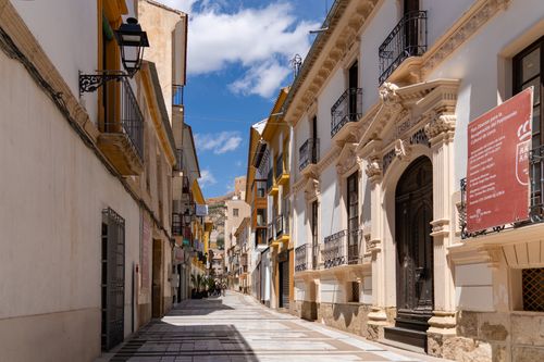 Free Charming street view in Lorca, Spain showcasing colorful historic architecture under a bright blue sky. Stock Photo