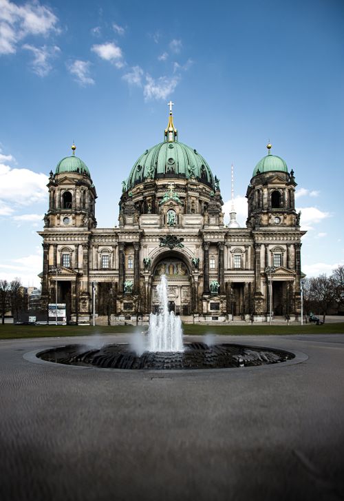 Free Stunning frontal view of Berlin Cathedral with a fountain in foreground, under a clear blue sky. Stock Photo