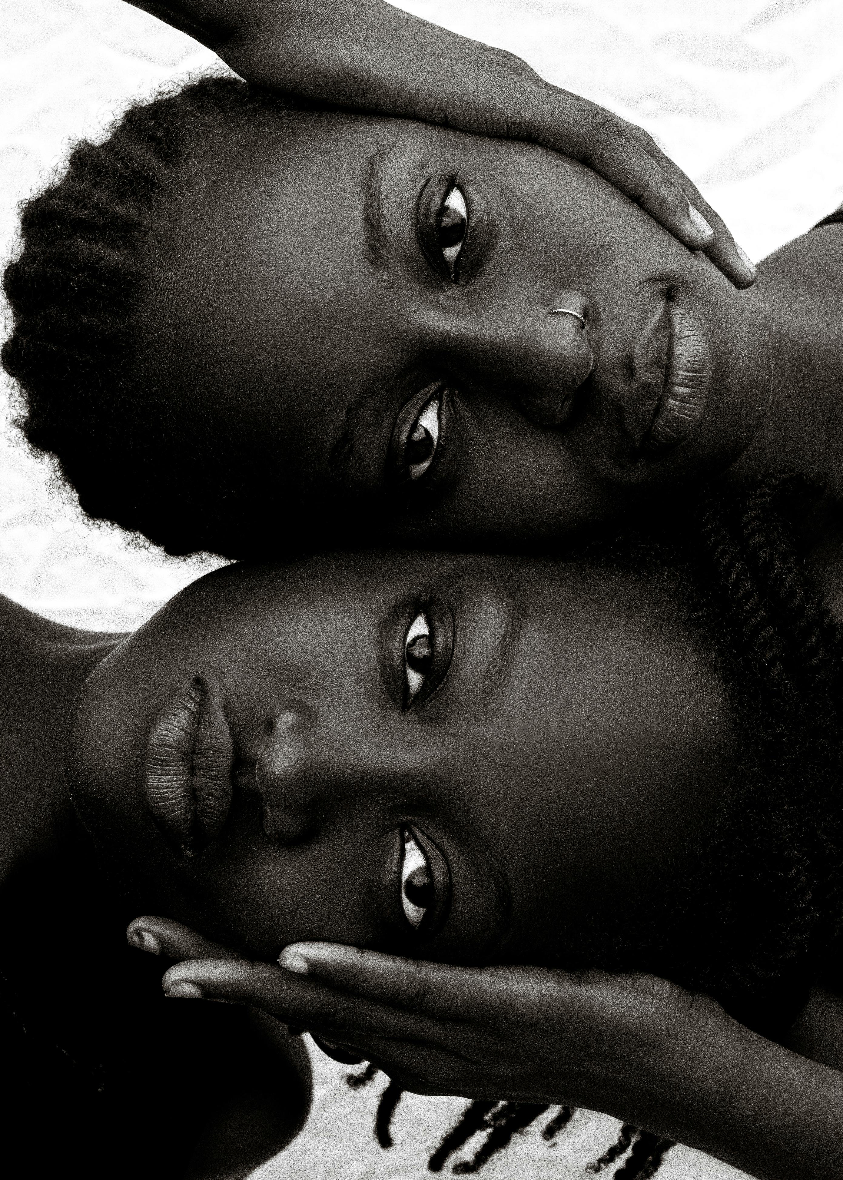 Black and white portrait of two women expressing deep emotion and connection.