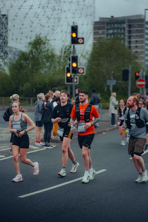 Free Runners participating in a marathon in Belfast, Northern Ireland with diverse urban backdrop. Stock Photo
