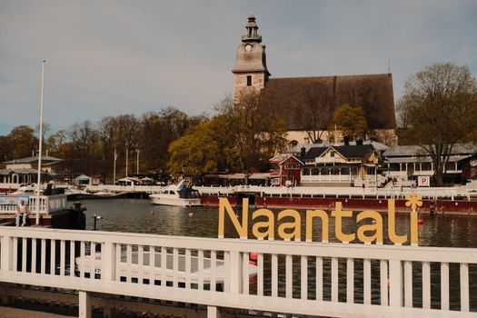 Charming springtime view of Naantali's waterfront and church in Southwest Finland.