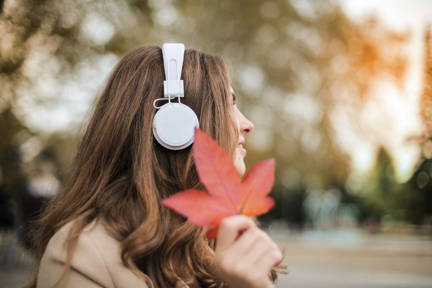 A person relaxing with eyes closed while listening to music through headphones