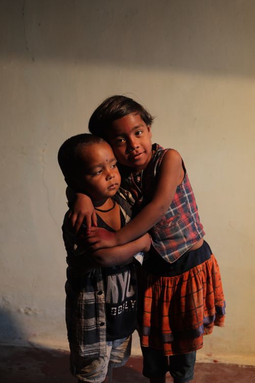 Free Two children embrace warmly, capturing a heartfelt moment in natural light. Stock Photo