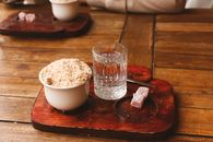 Wooden platter with Turkish breakfast, featuring crunchy topping and Turkish delight in Türkiye.