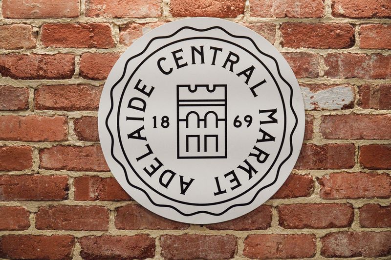 Adelaide Central Market sign on a brick wall