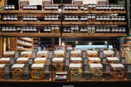 Variety of spices and herbs in jars and containers at Adelaide market.