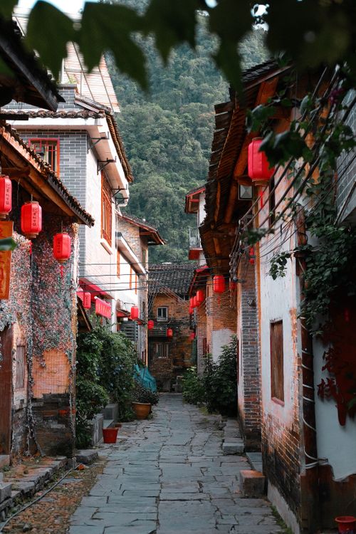 Free Scenic narrow street in Hezhou, China with red lanterns and traditional architecture. Stock Photo