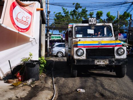 A colorful jeepney navigates the bustling streets of Cebu City, Philippines.