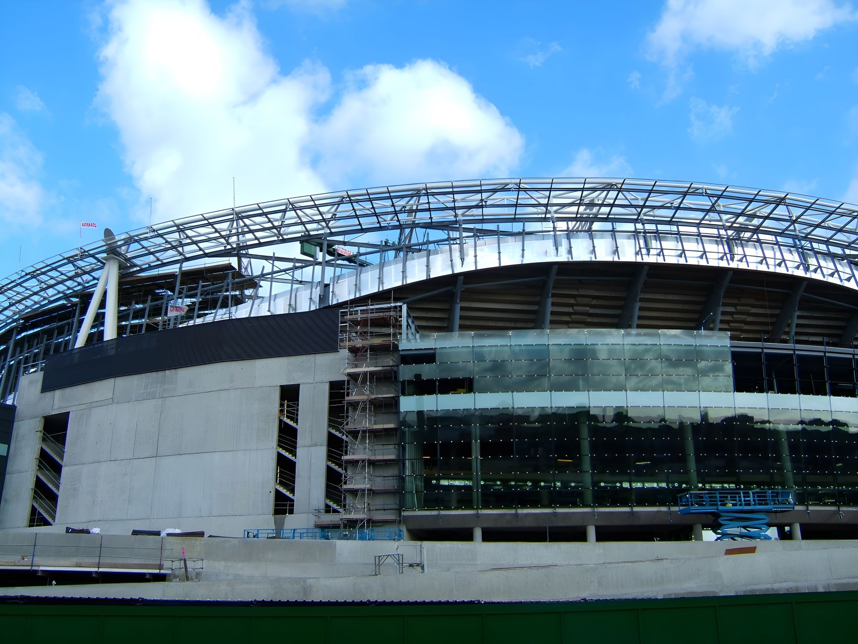 Emirates Stadium under construction in London, England, showcasing modern architecture.