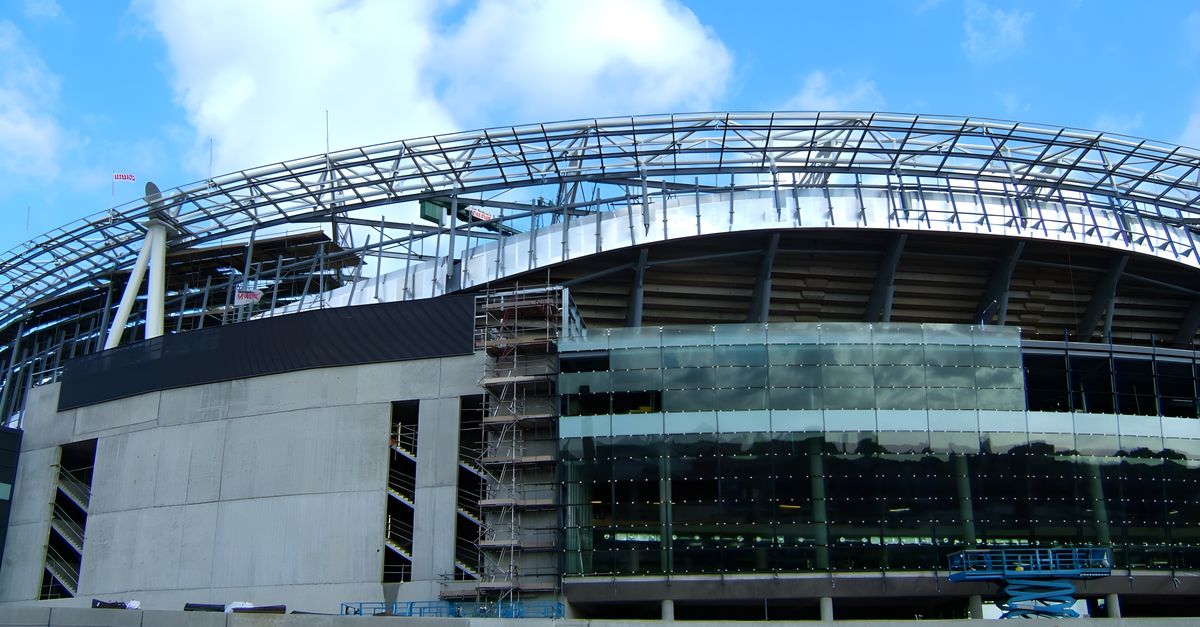 Emirates Stadium under construction in London, England, showcasing modern architecture.