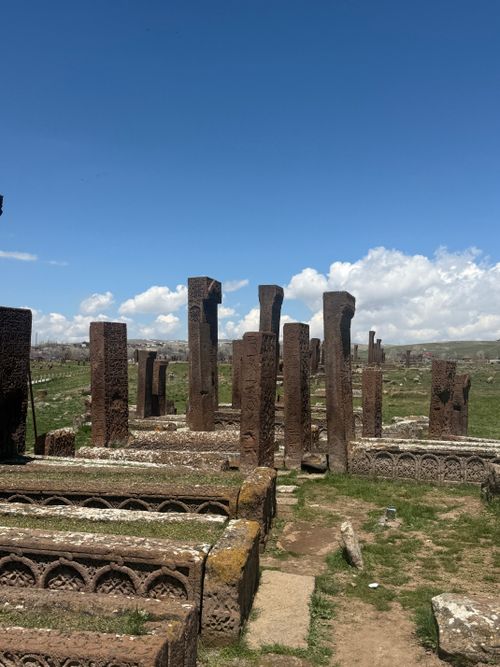 Free Rugged ancient stone monuments standing under a bright, clear blue sky on a grassy terrain. Stock Photo