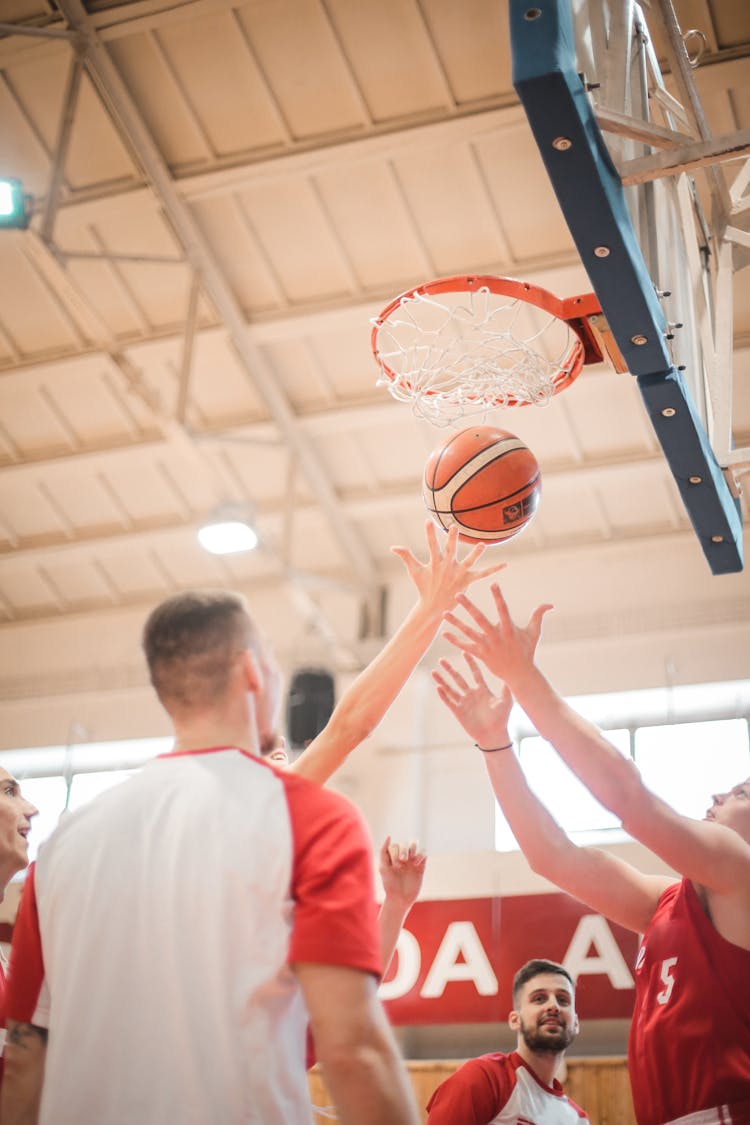 Sportsmen Playing Basketball On Modern Sports Court