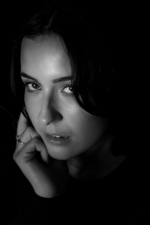 Free Intimate black and white portrait of a woman with dramatic lighting. Stock Photo