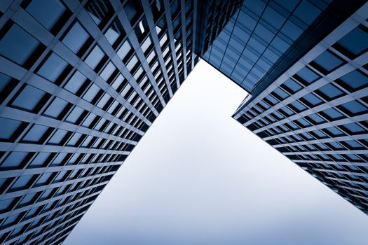 Modern skyscrapers forming a geometric pattern under a clear sky in Katowice.