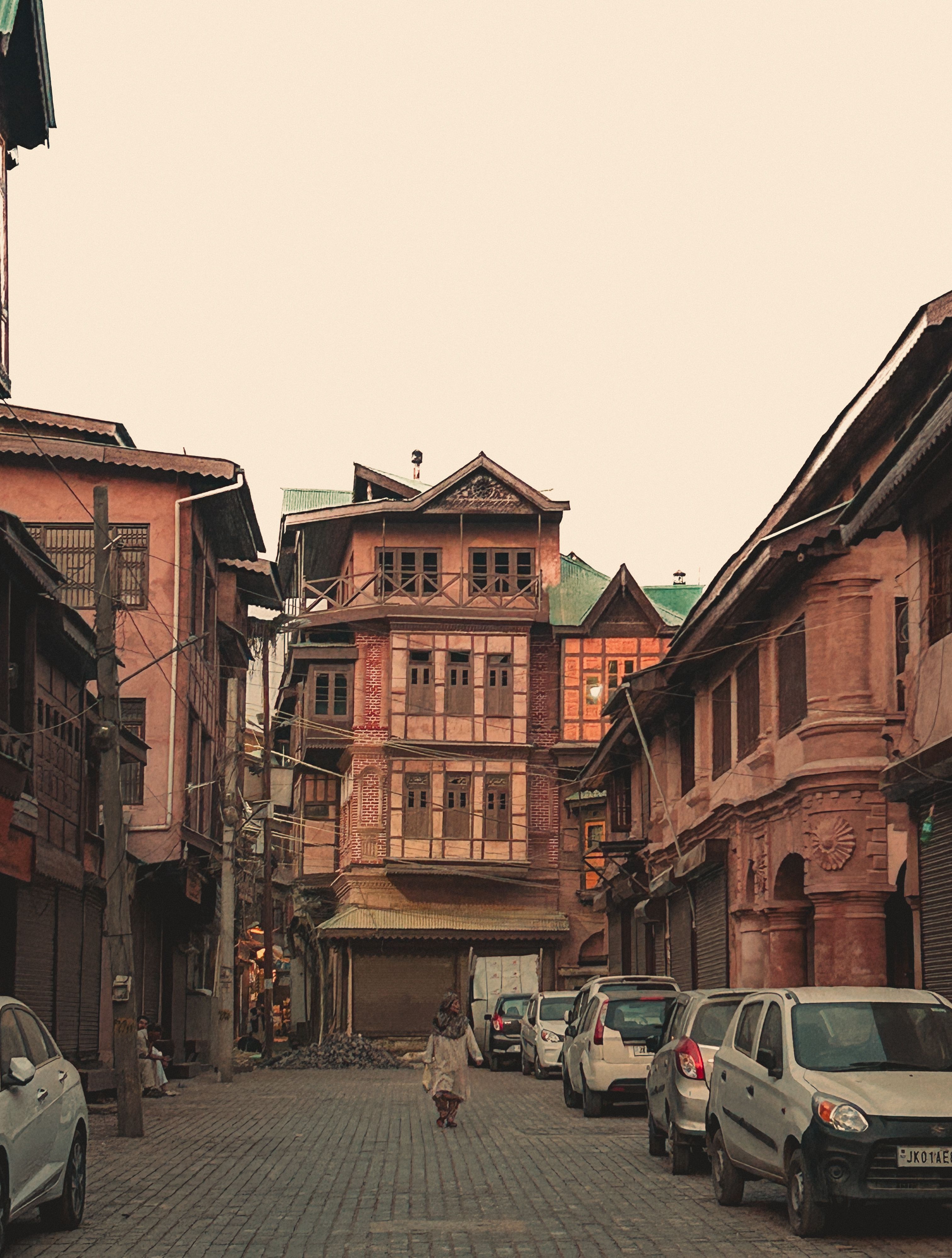 Explore the historic charm of traditional Kashmiri architecture along a serene street in Srinagar, India.