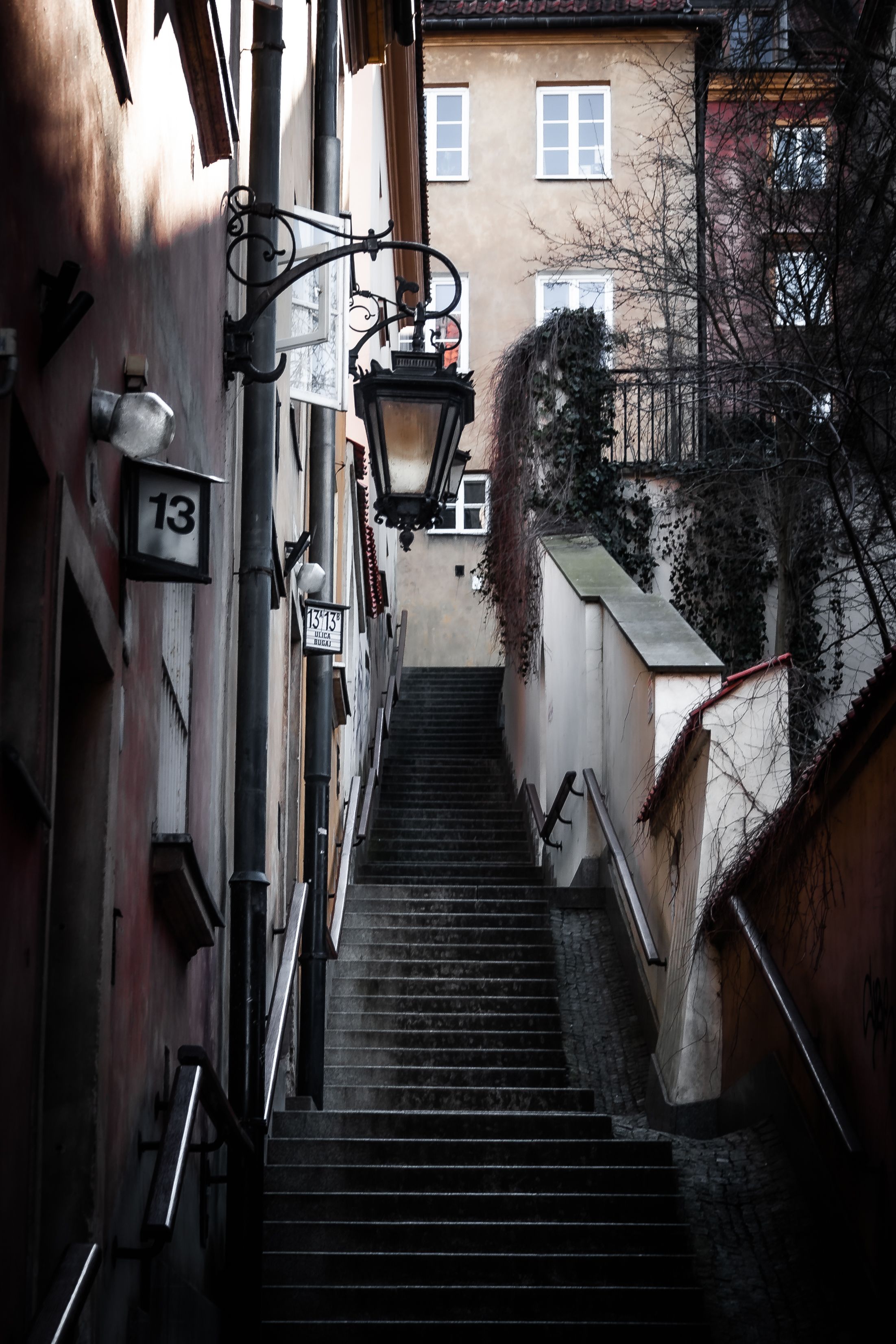 Atmospheric narrow staircase view in Warsaw's Old Town, showcasing historic architecture.