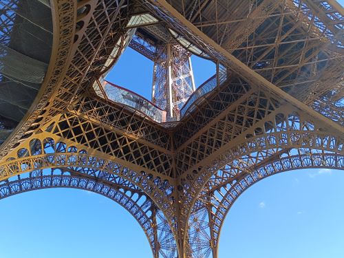Free Intricate view of the Eiffel Tower's iron latticework against a clear blue sky. Stock Photo