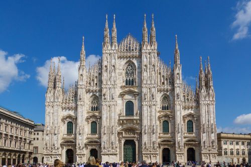 Free Stunning architectural view of the Milan Cathedral under a clear blue sky. A masterpiece of Gothic design. Stock Photo