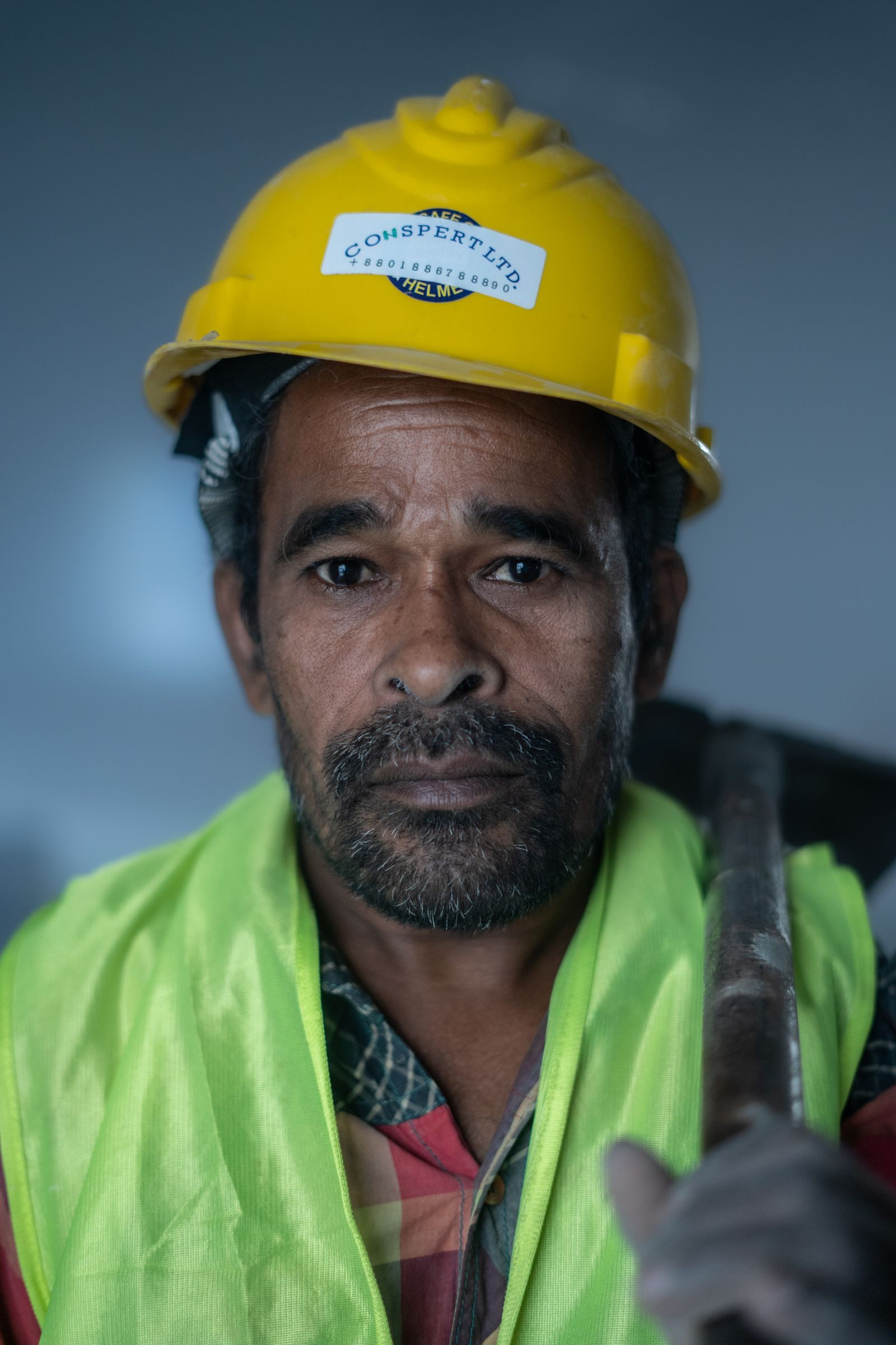 Construction worker wearing a hard hat and high-visibility safety gear