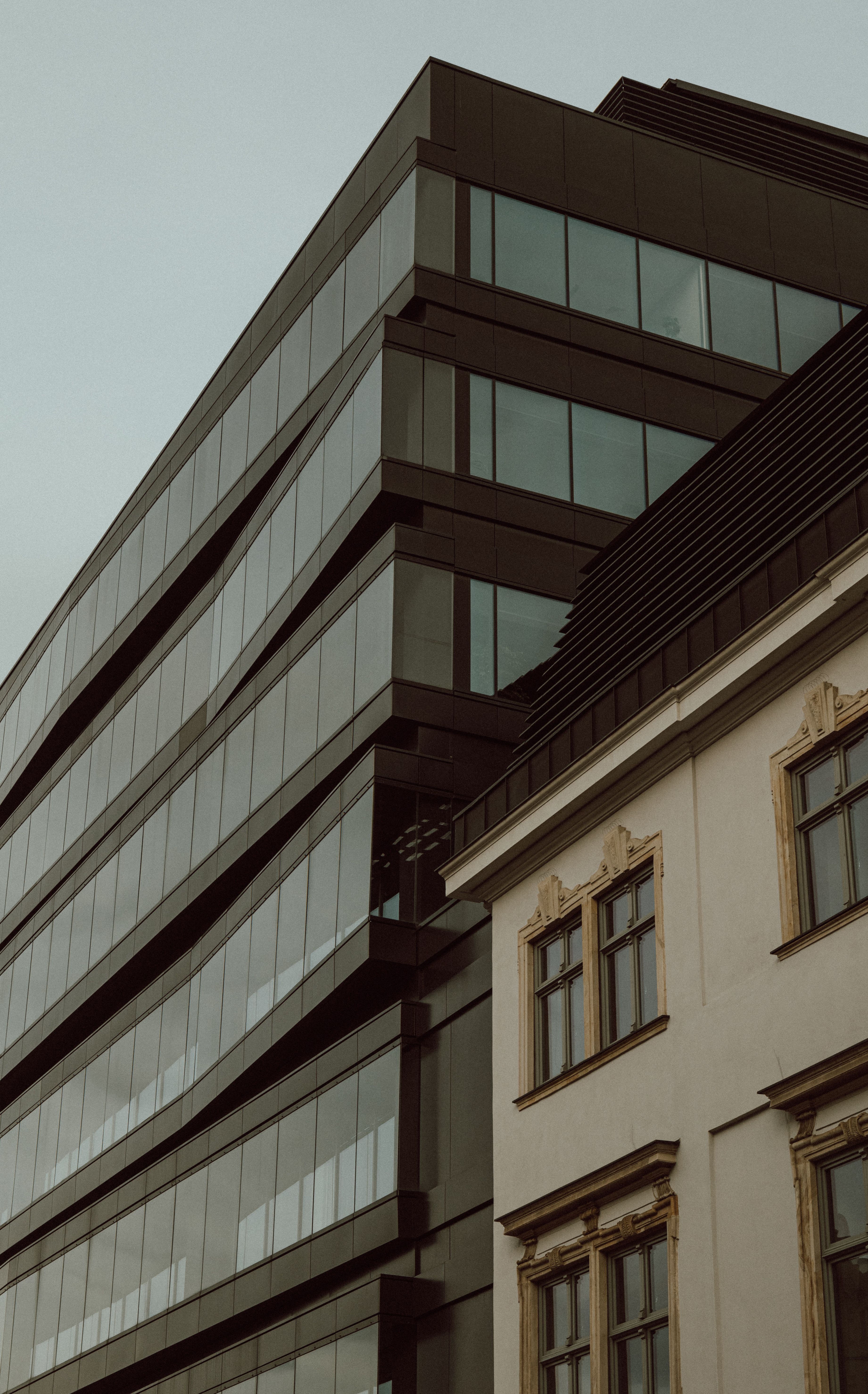 Modern Glass and Historic Building Contrast · Free Stock Photo
