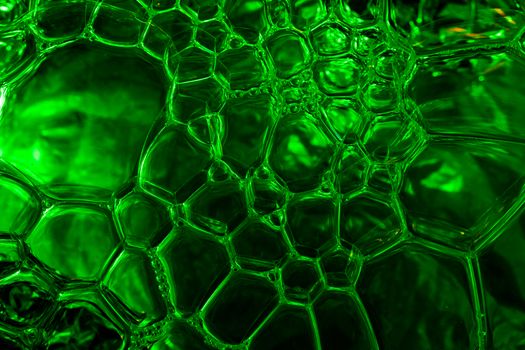 Vivid close-up of green soap bubbles showcasing intricate patterns, captured in Valencia, Spain.
