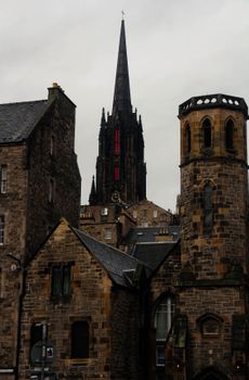 Gothic spire and historic stone buildings in Edinburgh's Old Town, Scotland.