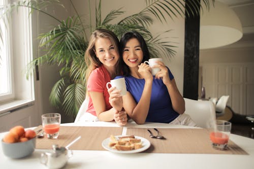 Free Photo Of Women Leaning On Each Other Stock Photo