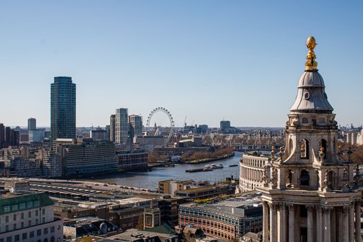 A picturesque view of London's skyline featuring the iconic London Eye and river Thames.